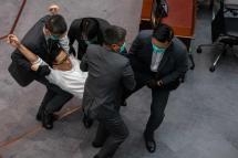 (FILE) - Pro-democracy lawmaker Lam Cheuk-ting (2-L, in white shirt), is carried out of the chamber by security guards during a scuffle with pro-Beijing lawmakers at a the Legislative Council meeting in Hong Kong, China, 18 May 2020. Photo: EPA