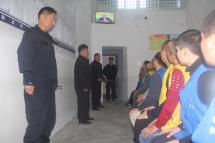 This undated handout image released by The Victims of Communism Memorial Foundation on May 24, 2022, shows detainees guarded by police as they watch a televised speech by the then Governor of Ili Prefecture Nurlan Abdumalin at the Tekes County Detention Centre in the Xinjiang Region of western China. Photo: AFP