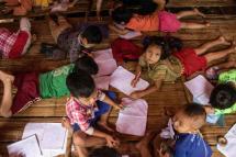 Children attend a class in a temporary shelter at a camp for internally displaced people in Demoso township in Myanmar's Kayah state in October. Photo: AFP