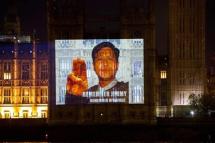 The Houses of Parliament are lit up with images of a Myanmar dissident and a portrait by the Portuguese artist, Paulo Andringa, of a prisoner of conscience from Myanmar, that is made up of thousands of smaller pictures of prisoners of conscience, to mark World Human Rights Day on December 8, 2022 in London, England. Photo: Twitter