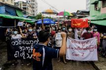  A man records protesters on his mobile phone as they take part in a demonstration against the military coup in Yangon, myanmar, 21 May 2021. Photo: AFP