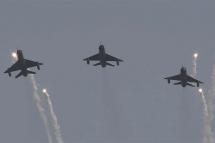 Three Soviet-era MiG-21 aircrafts flying in an air arms show. Photo: AFP