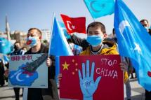 Members of the Muslim Uighur minority hold placards as they demonstrate to ask for news of their relatives and to express their concern about the ratification of an extradition treaty between China and Turkey at Uskudar square in Istanbul on February 26, 2021. Photo: AFP