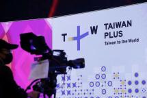 This handout photo taken and released by the Taiwan Presidential Office on October 3, 2022 shows a man taking video of a ceremony to launch the new English-language TV channel TaiwanPlus in Taipei. Photo: HANDOUT / Taiwan Presidential Office / AFP