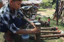 This screengrab from AFPTV video footage taken on October 15, 2022 shows members of the People Revolution Army (PRA) preparing homemade weapons in Pale township. Photo: AFP