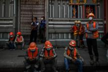 Construction workers gather during a protest to demand recognition of their labour rights, as some said they did not receive their full wages, in Yangon. Photo: AFP