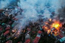 This aerial photo taken on October 29, 2021 show smokes and fires from Thantlang, in Chin State, where more than 160 buildings have been destroyed caused by shelling from Junta military troops, according to local media. STR / AFP