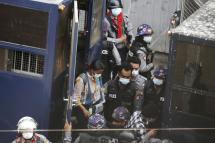 Myanmar Now journalist Kay Zon Nway is taken by police officers on February 27 in Yangon’s Sanchaung township. Photo: EPA