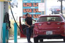 A customer pumps gas into their car at a gas station on May 18, 2022 in Petaluma, California. Gas prices in California have surpassed $6.00 per gallon for the first time ever. The average price per gallon of regular unleaded gasoline in California is at $6.05 and $6.29 in the San Francisco Bay Area. Photo: AFP