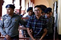 Detained Reuters journalist Wa Lone (2-R) is escorted out of court by police after his trial in Yangon, Myanmar, 17 July 2018. Photo: Nyein Chan Naing/EPA
