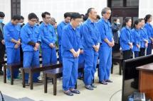 This picture taken and released on February 15, 2023 by the Vietnam News Agency shows South Korean and Vietnamese defendants at a trial for people smuggling in Danang. Photo: AFP