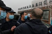 Security personnel are seen as members of the World Health Organization (WHO) team investigating the origins of the COVID-19 coronavirus, arrive at the Wuhan Institute of Virology in Wuhan, in China's central Hubei province on February 3, 2021. Photo: AFP