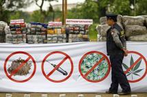 A Myanmar policeman walks past a pile of drugs prior to a 'Destruction Ceremony of Seized Narcotic Drugs' to mark International Day against Drug Abuse, in Yangon, Myanmar, 26 June 2014.  Photo: EPA