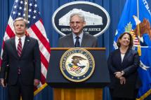  US Attorney General Merrick B. Garland (C), flanked by Deputy Attorney General Lisa O. Monaco (R) and FBI Director Christopher Wray (L), speaks to the media about national security cases addressing 'malign influence schemes' from China at the Department of Justice in Washington, DC, USA, 24 October 2022. Photo: EPA