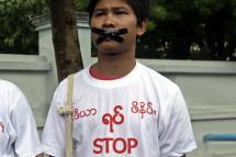 (FILE) Reuters journalist Wa Lone wearing a t-shirt with a slogan reading, 'Stop killing press' and tapes on his mouth takes part in a protest over their jailed colleagues (on 10 July five journalists in Myanmar were sentenced to 10 years in jail each, charged with disclosing state secrets for publishing a report on an alleged chemical weapons factory in the country's central region.), near the Myanmar Peace Center in Yangon, Myanmar, 12 July 2014 (issued 14 December 2017). Photo: Nyein Chan Naing/EPA
