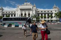Tourists walking in front of City Hall in the downtown area of Yangon. Photo: Ye Aung Thu/AFP