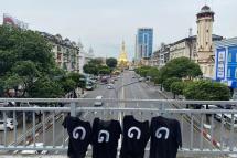 A handout photo made available by the Democratic Party for a New Society (DPNS) shows the number '8888' in Burmese digits printed on black T-shirts hanging on a bridge near the Sule pagoda (background) during a protest on the day of the anniversary of the '8888 Uprising' in downtown Yangon, Myanmar, 08 August 2023. Photo: EPA
