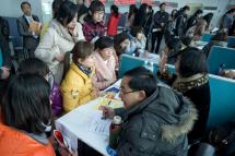 (File) Unemployed women ask for information from recruiters at a job fair in Qingdao city, eastern China's Shandong province. Photo: EPA